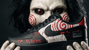Hand painted custom sneakers featuring Jigsaw and Billy the puppet designs from Saw, by Sneakcares
